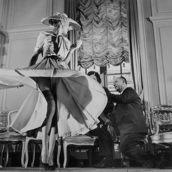 Christian Dior with Woman Modeling Dress and Stockings